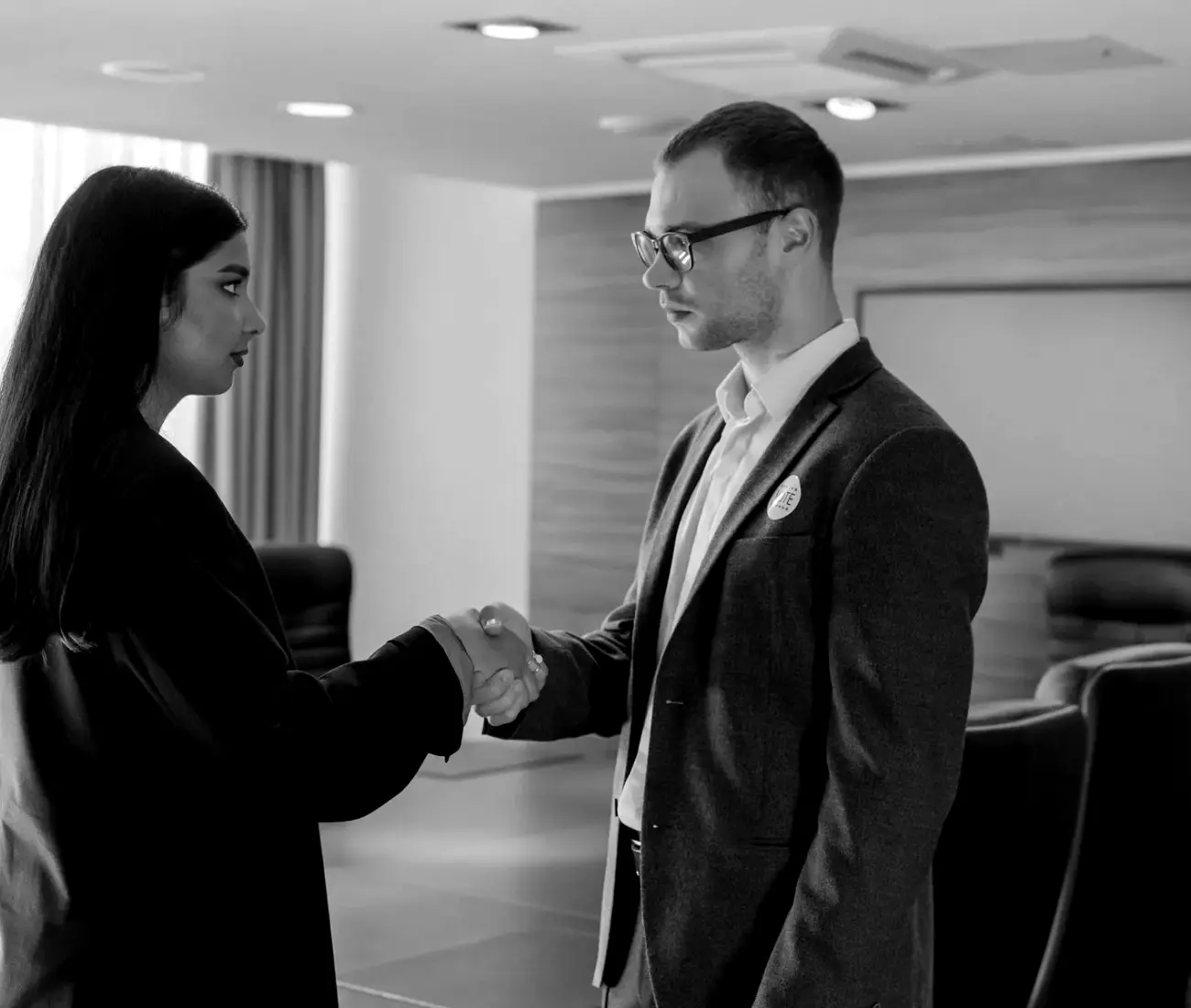 Two people shaking hands in an office